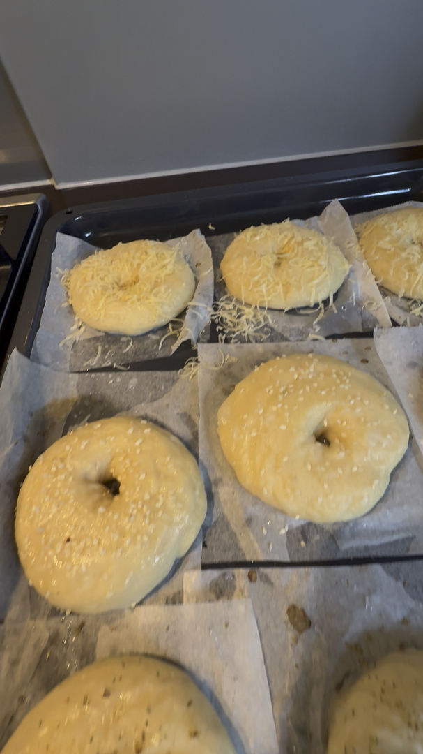 Proofed sourdough bagels with sesame and cheese